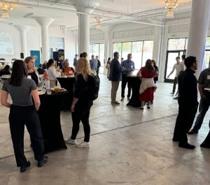 Attendees standing at high tops during Epic + USGBC event