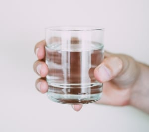 hand holding a glass of water