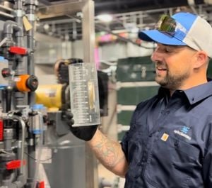 Director of Onsite Reuse Operations for Epic Cleantec, Ryan Pulley, holding a beaker of treated wastewater in one of our onsite reuse installations