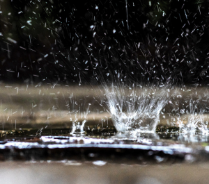 rainwater hitting the ground, creating a splash